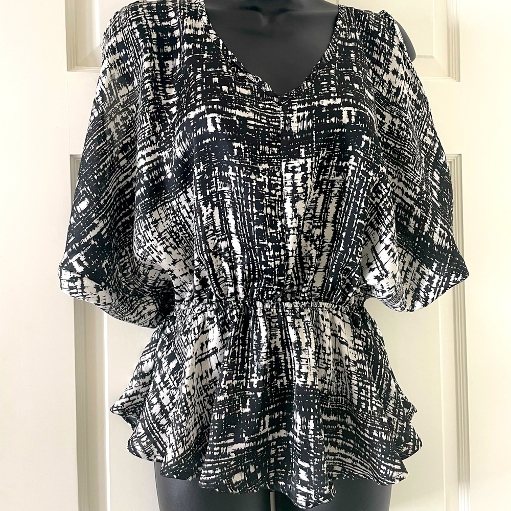 Cherish peplum blouse with cold shoulder and open back.
